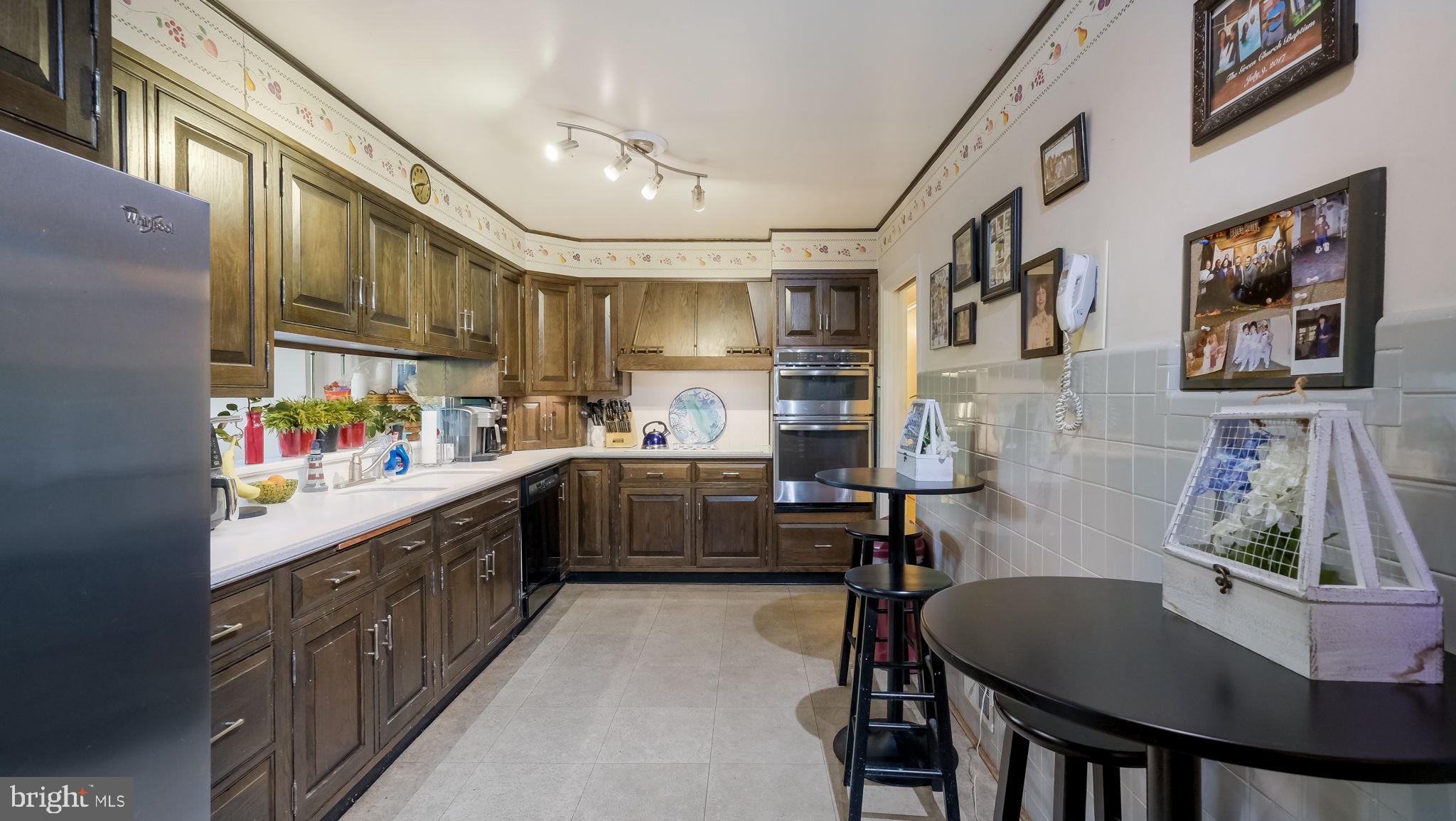 1591 Middletown Road Glen Mills, PA 19342 - Photo 12 of 55 a kitchen with stainless steel appliances granite countertop a sink and cabinets