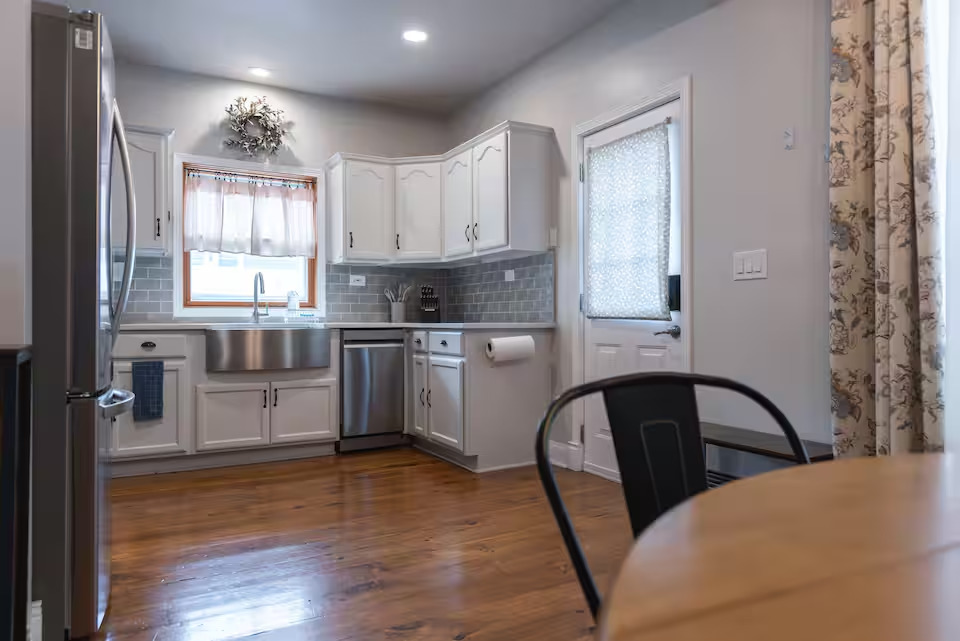 300 Division Street South Elgin, IL 60177 - Photo 10 of 23 a kitchen with a table chairs a sink dishwasher window and cabinets