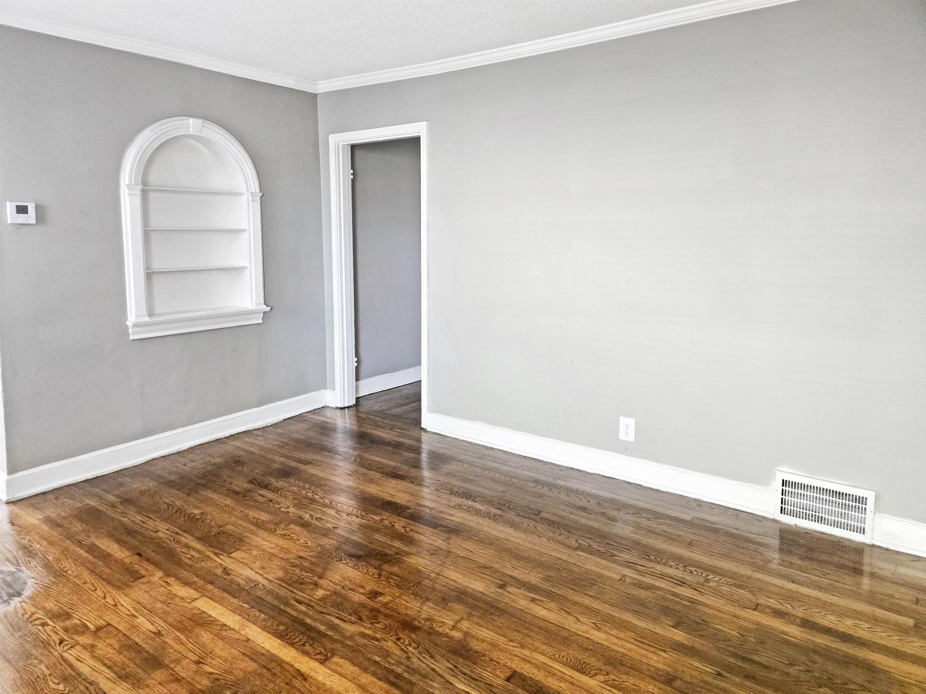 2667 Barron Avenue Memphis, TN 38114 - Photo 3 of 14 an empty room with wooden floor and windows