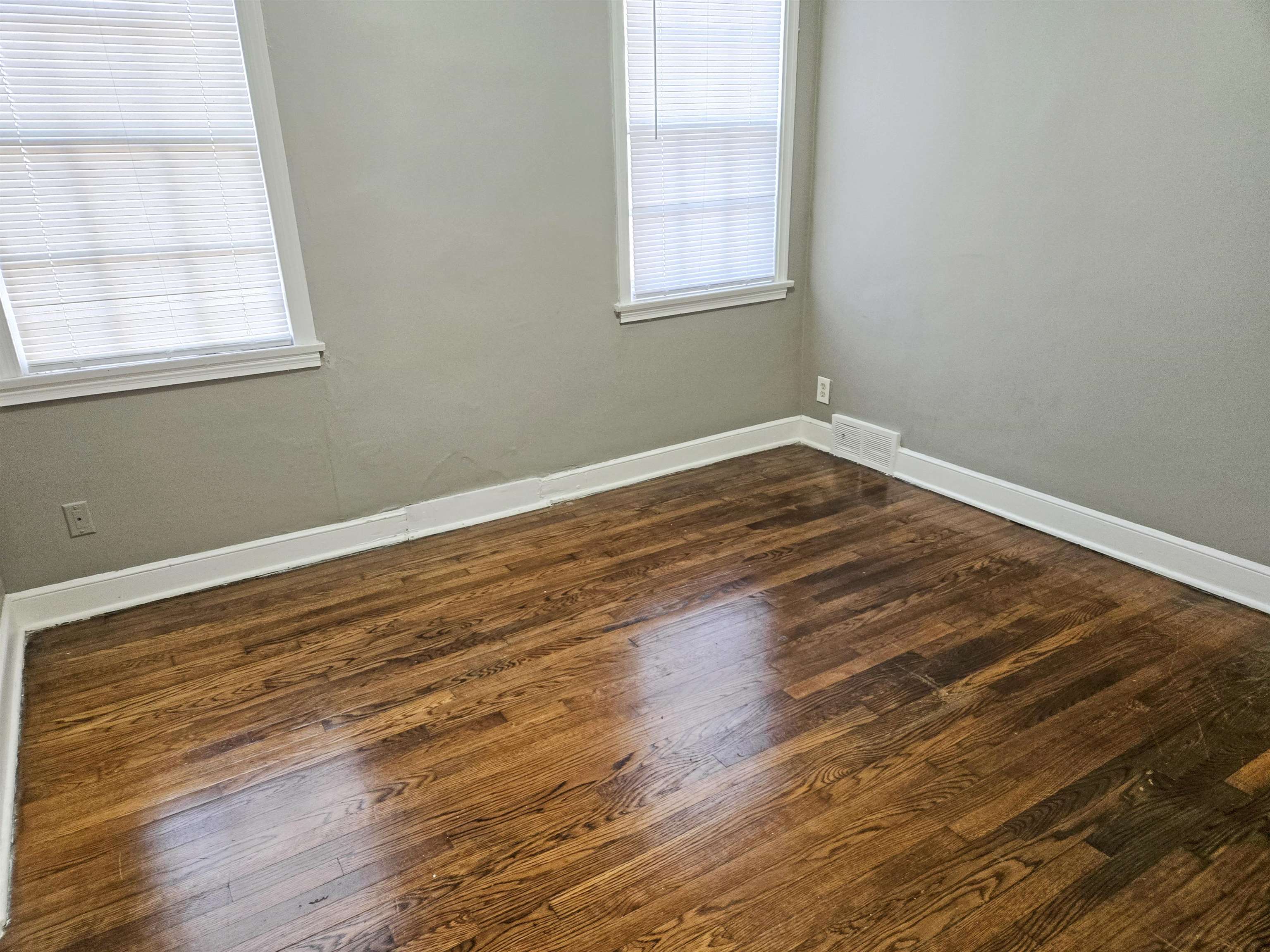 2667 Barron Avenue Memphis, TN 38114 - Photo 7 of 14 an empty room with wooden floor and windows