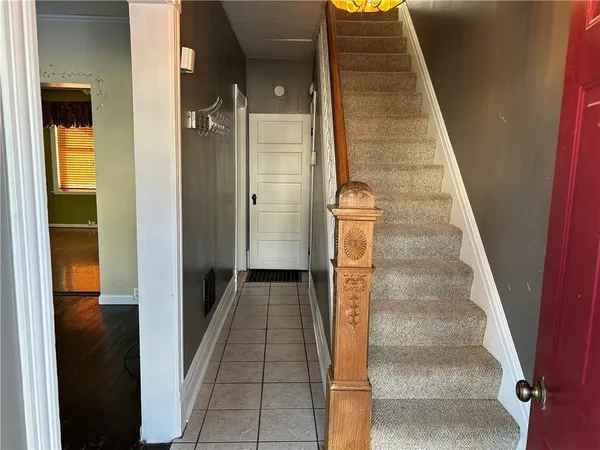 a view of a hallway with wooden floor and entryway