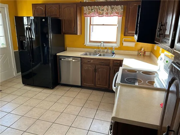 a kitchen with a refrigerator and a sink