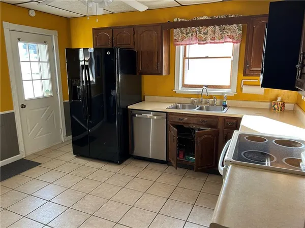a kitchen with stainless steel appliances granite countertop a refrigerator and a sink