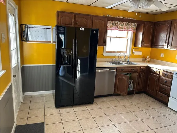 a kitchen with stainless steel appliances granite countertop a stove a sink and a refrigerator