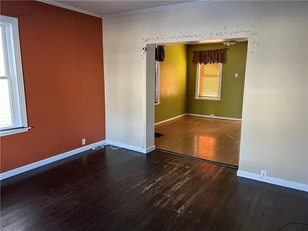 an empty room with wooden floor and closet