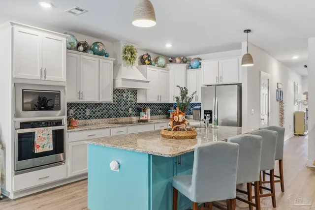 a living room with furniture and kitchen view