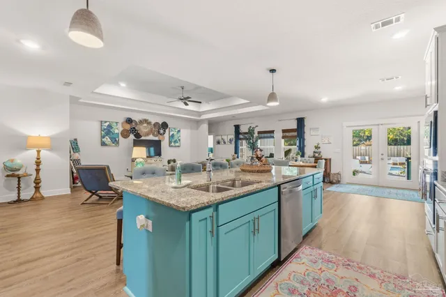 a living room with furniture and paintings on the wall