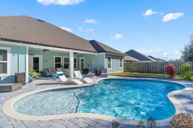 a view of a house with backyard porch and sitting area