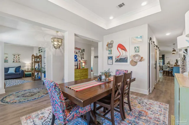 a bedroom with a bed a couch and a chandelier