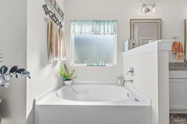 an aerial view of residential houses with outdoor space and parking