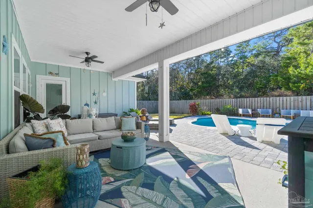 an aerial view of a house with a swimming pool outdoor seating and yard