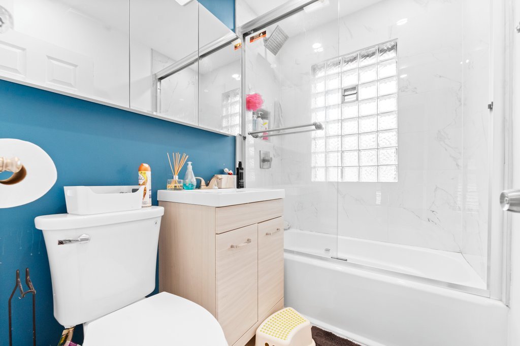1224 Grove Avenue Berwyn, IL 60402 - Photo 12 of 23 a bathroom with a sink a toilet and bathtub