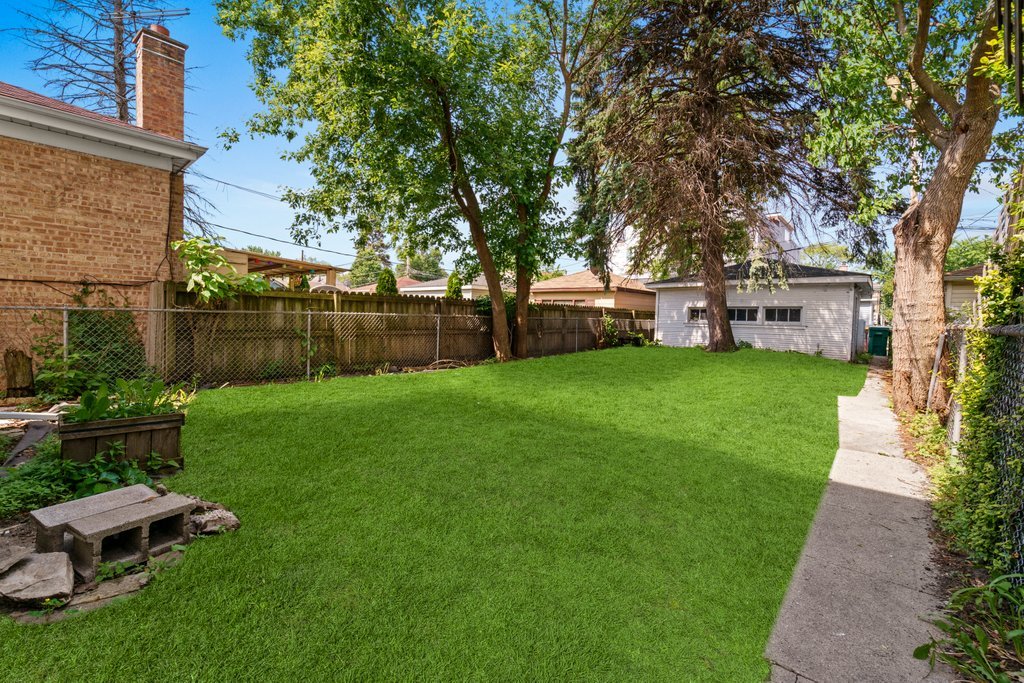 1224 Grove Avenue Berwyn, IL 60402 - Photo 4 of 23 a view of a backyard with table and chairs and potted plants and large trees