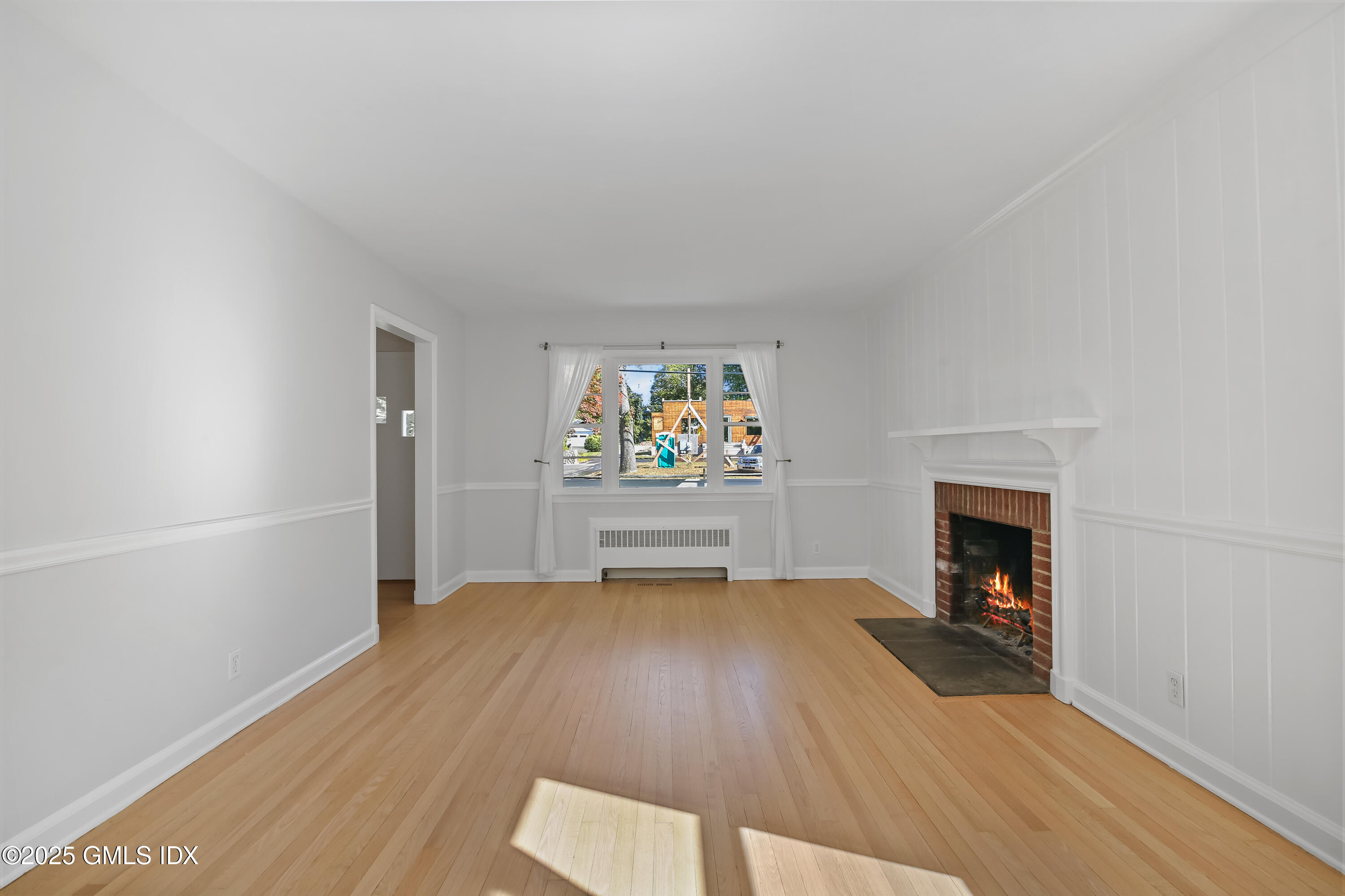 84 Indian Field Road Greenwich, CT 06830 - Photo 13 of 40 a view of a livingroom with wooden floor and a fireplace
