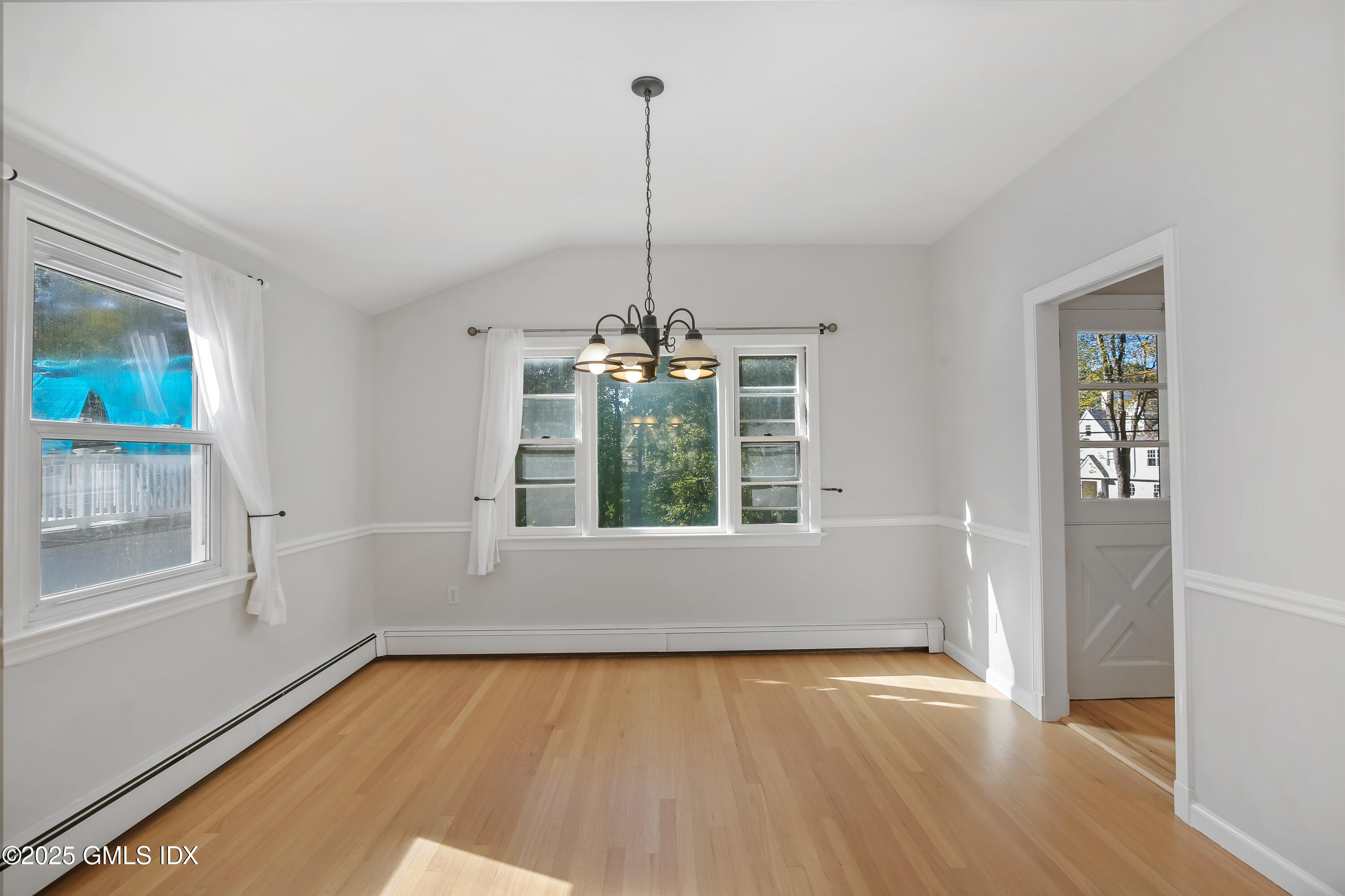 84 Indian Field Road Greenwich, CT 06830 - Photo 14 of 40 a view of an empty room with a window and wooden floor
