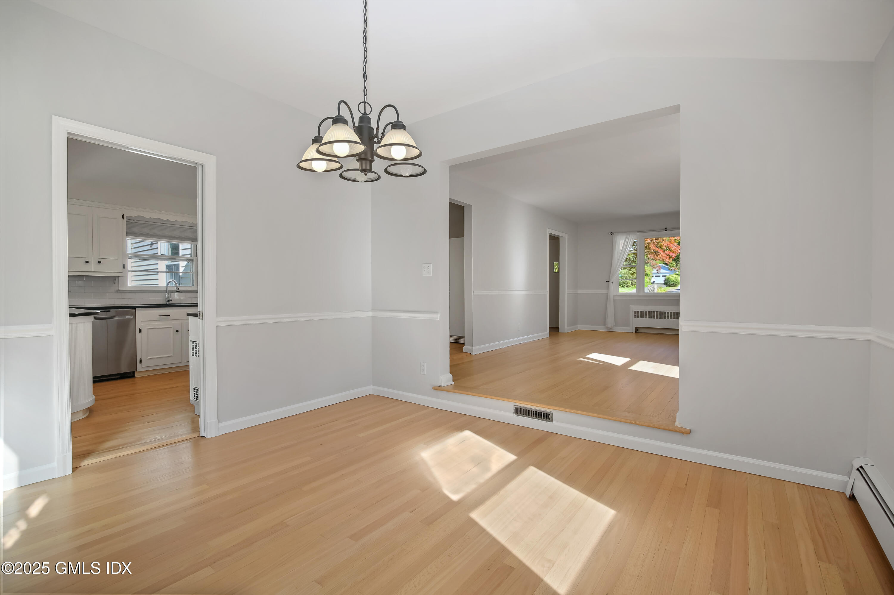 84 Indian Field Road Greenwich, CT 06830 - Photo 16 of 40 a view of a livingroom with wooden floor and a kitchen space