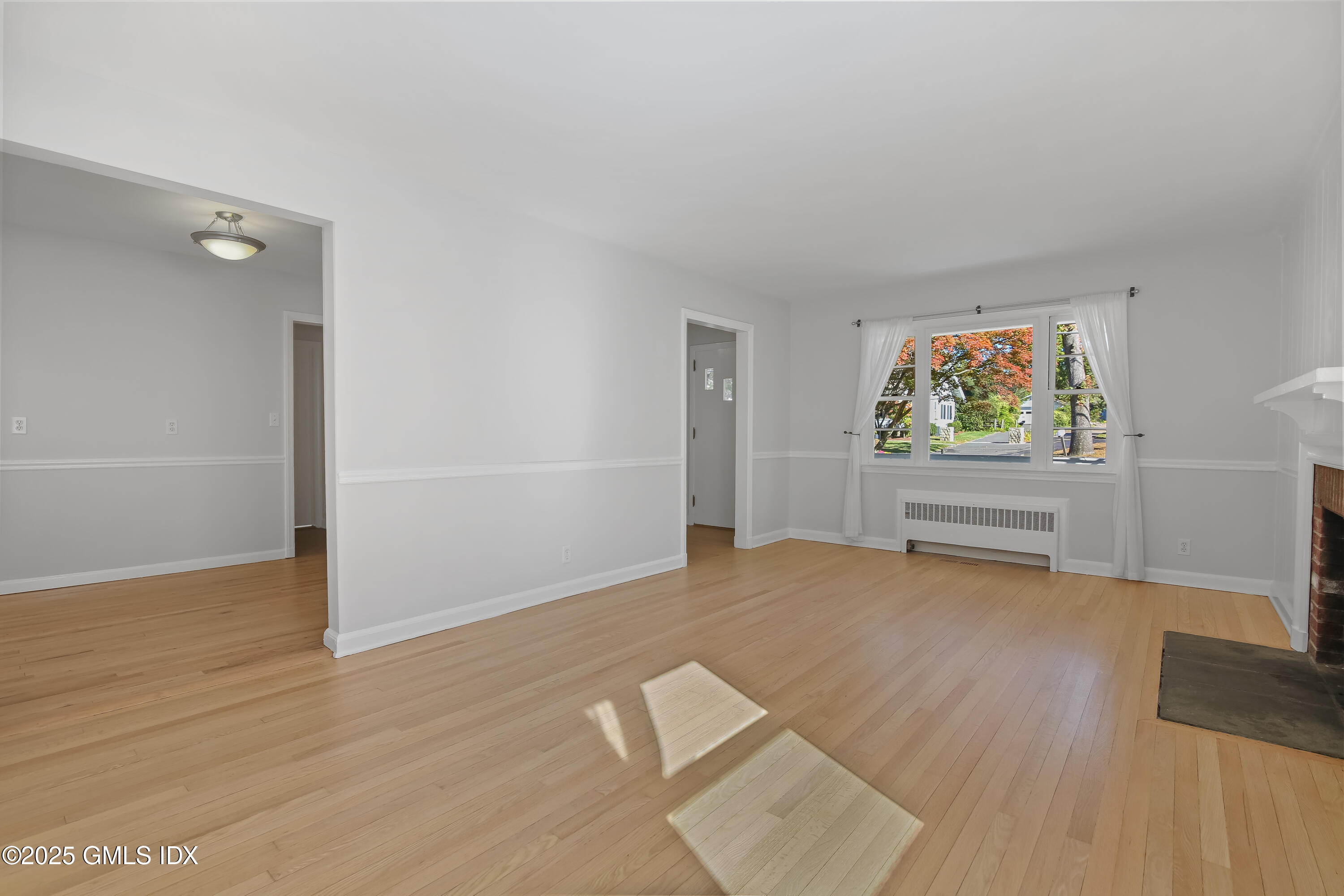 84 Indian Field Road Greenwich, CT 06830 - Photo 17 of 40 a view of empty room with wooden floor and window