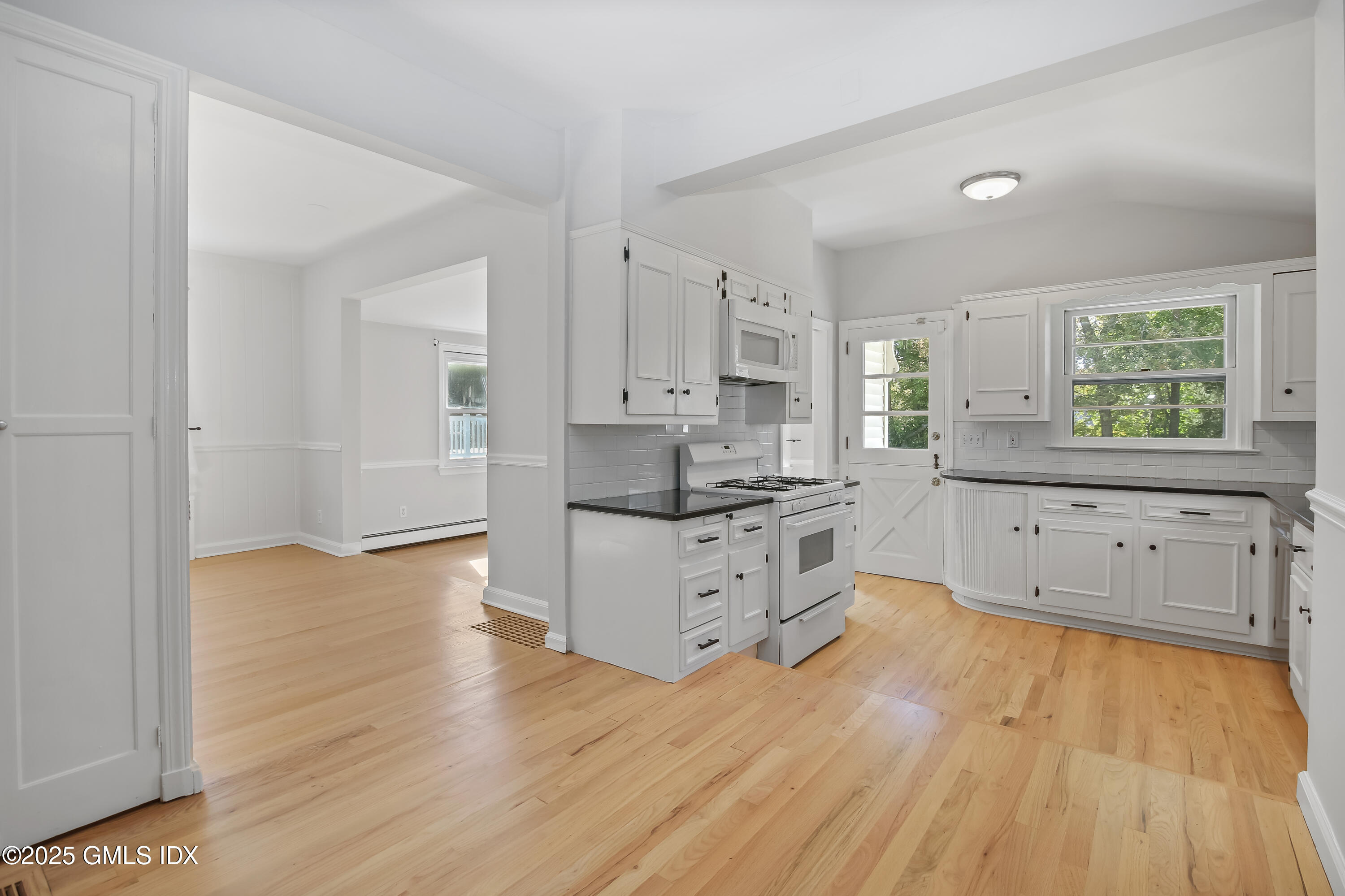 84 Indian Field Road Greenwich, CT 06830 - Photo 18 of 40 a kitchen with wooden floors and white cabinets