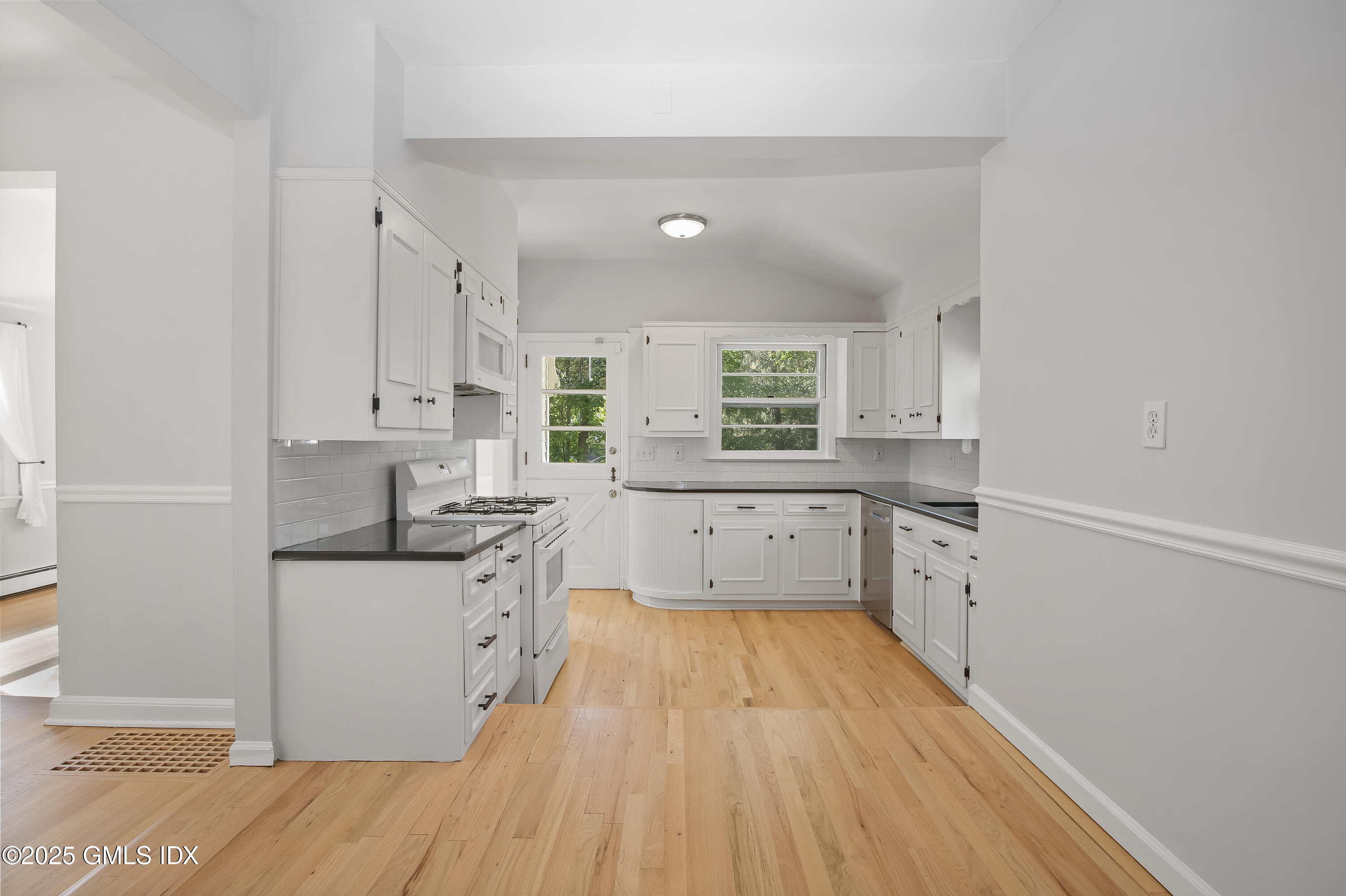 84 Indian Field Road Greenwich, CT 06830 - Photo 19 of 40 a kitchen with a sink a counter top space stainless steel appliances and a window