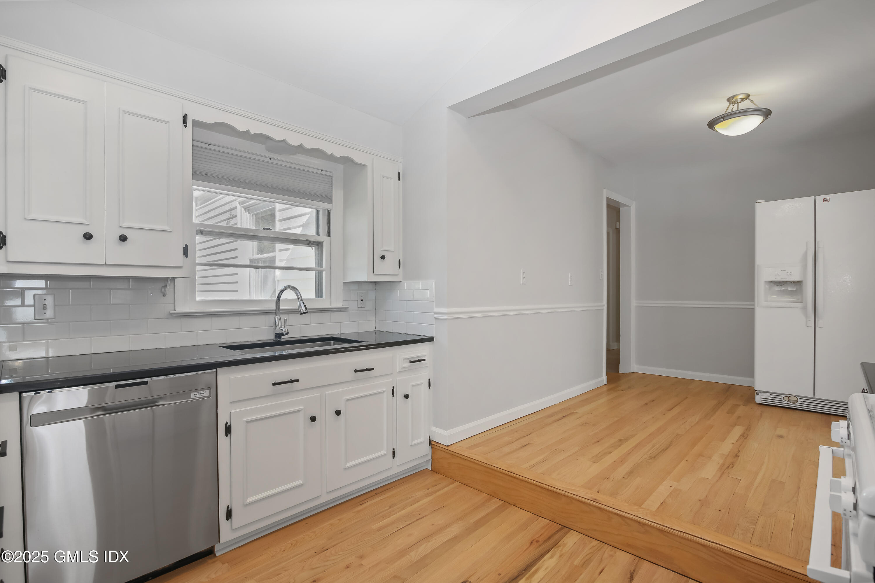84 Indian Field Road Greenwich, CT 06830 - Photo 21 of 40 a kitchen with granite countertop white cabinets and white appliances