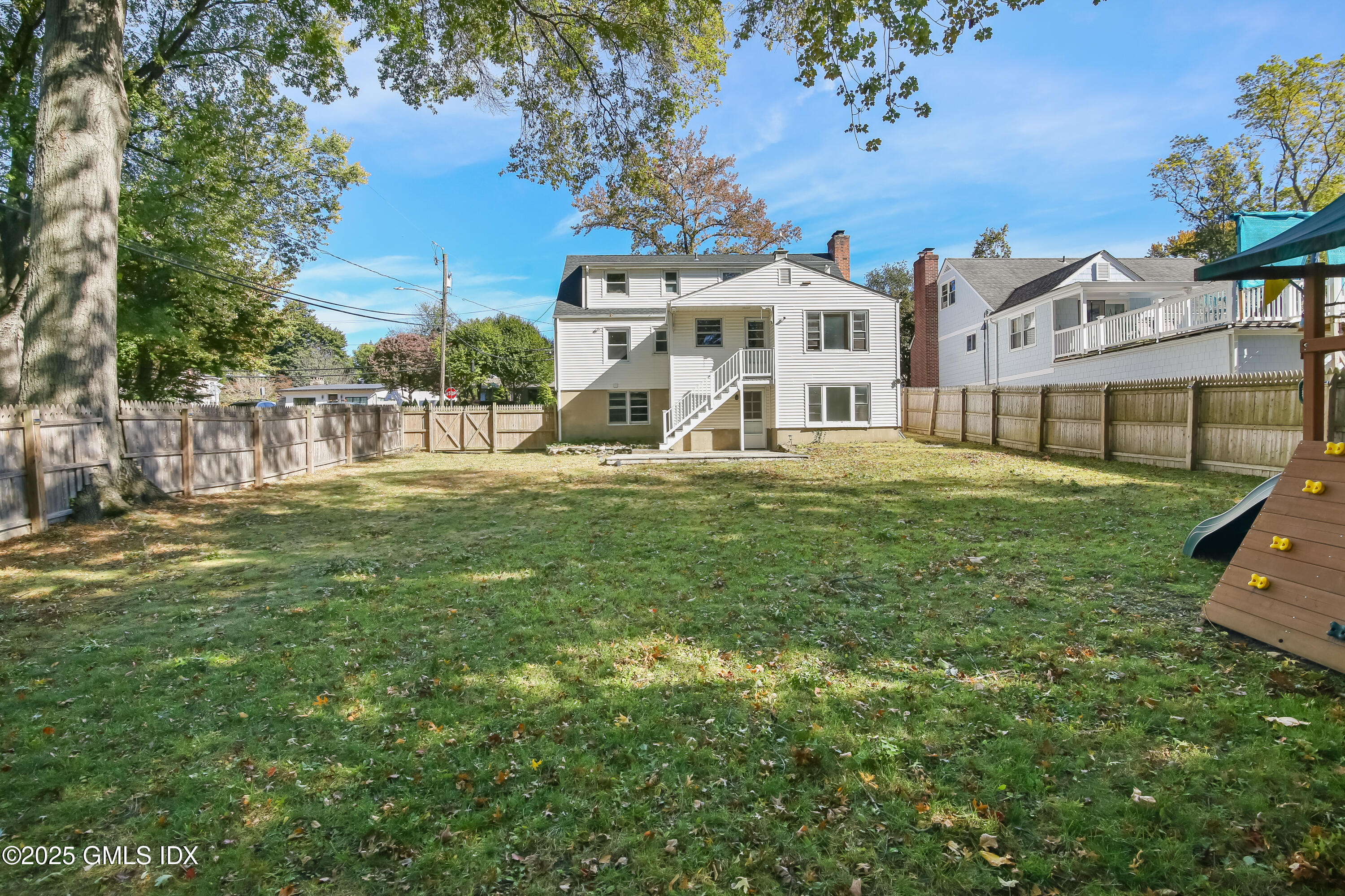 84 Indian Field Road Greenwich, CT 06830 - Photo 36 of 40 a big white building with a yard in front and a fountain