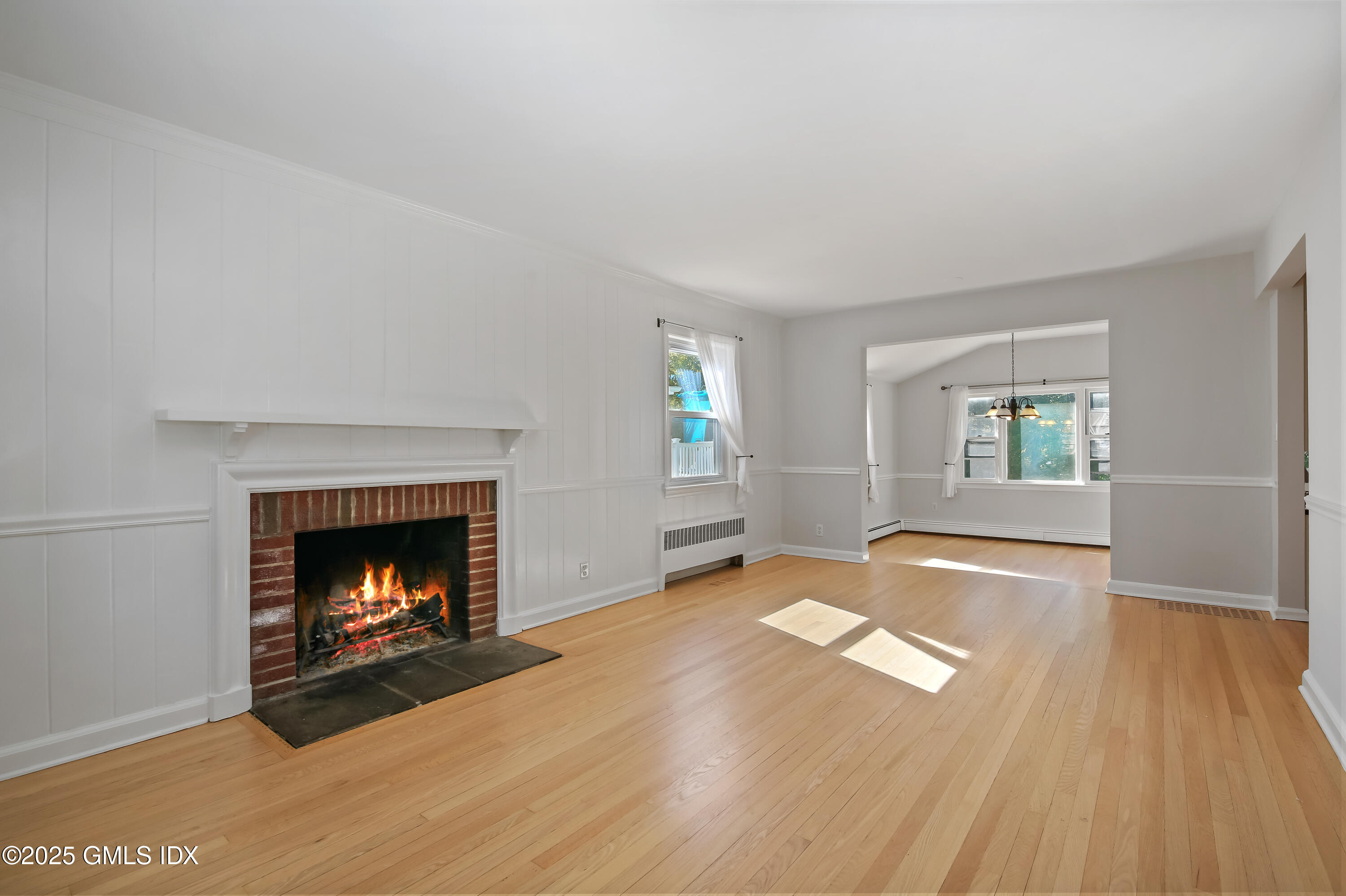 84 Indian Field Road Greenwich, CT 06830 - Photo 8 of 40 a view of empty room with wooden floor and fireplace