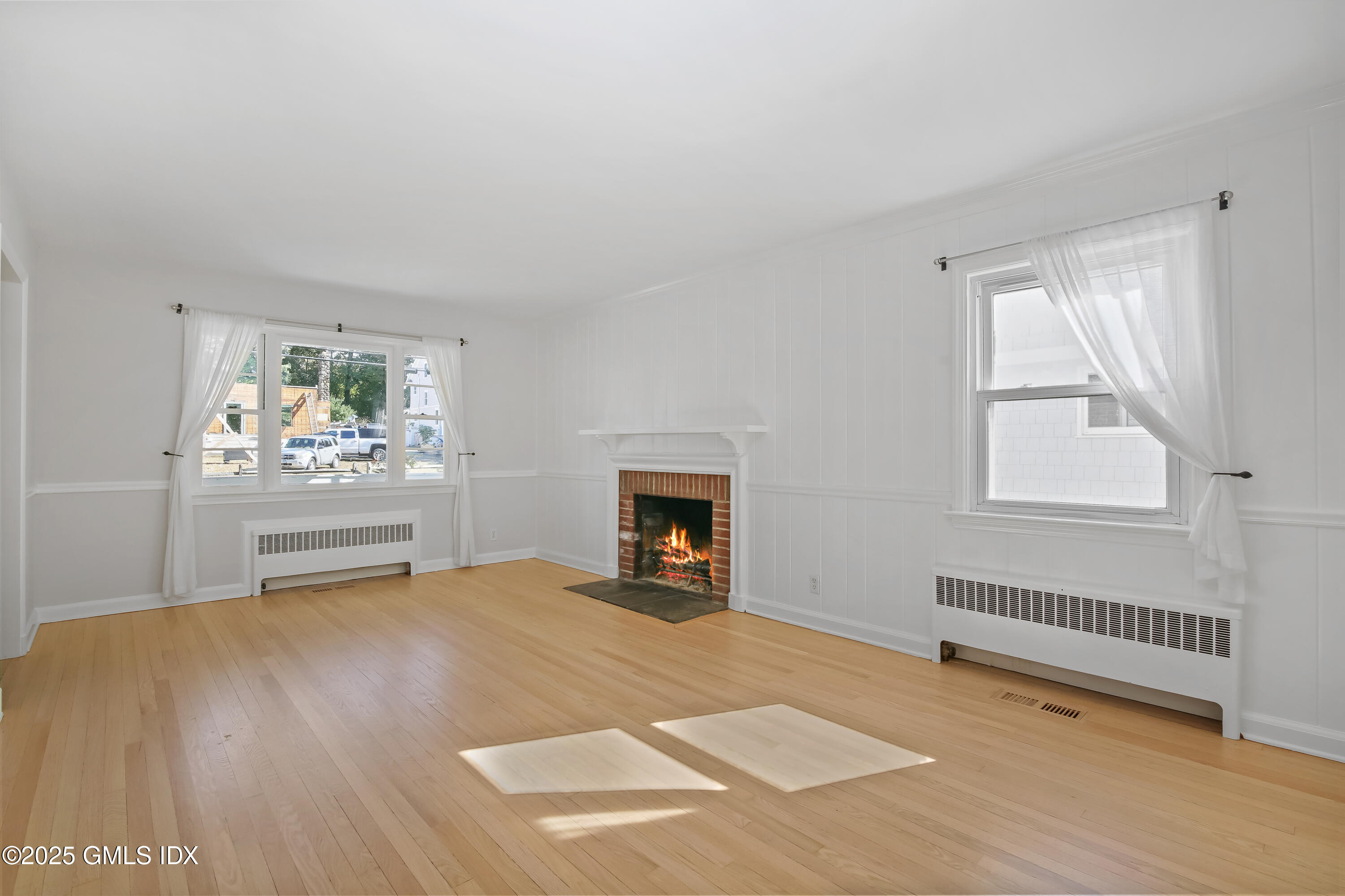 84 Indian Field Road Greenwich, CT 06830 - Photo 10 of 40 a view of an empty room with a window and fire place