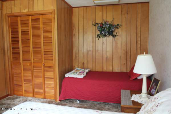 8948 San Rae Road Jacksonville, FL 32257 - Photo 11 of 15 a bed room with a bed and a window