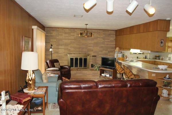 8948 San Rae Road Jacksonville, FL 32257 - Photo 3 of 15 a living room with furniture a fireplace and a lamp