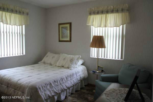 8948 San Rae Road Jacksonville, FL 32257 - Photo 8 of 15 a bedroom with a bed and a window