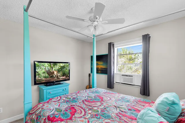 a bedroom with a bed and a flat screen tv