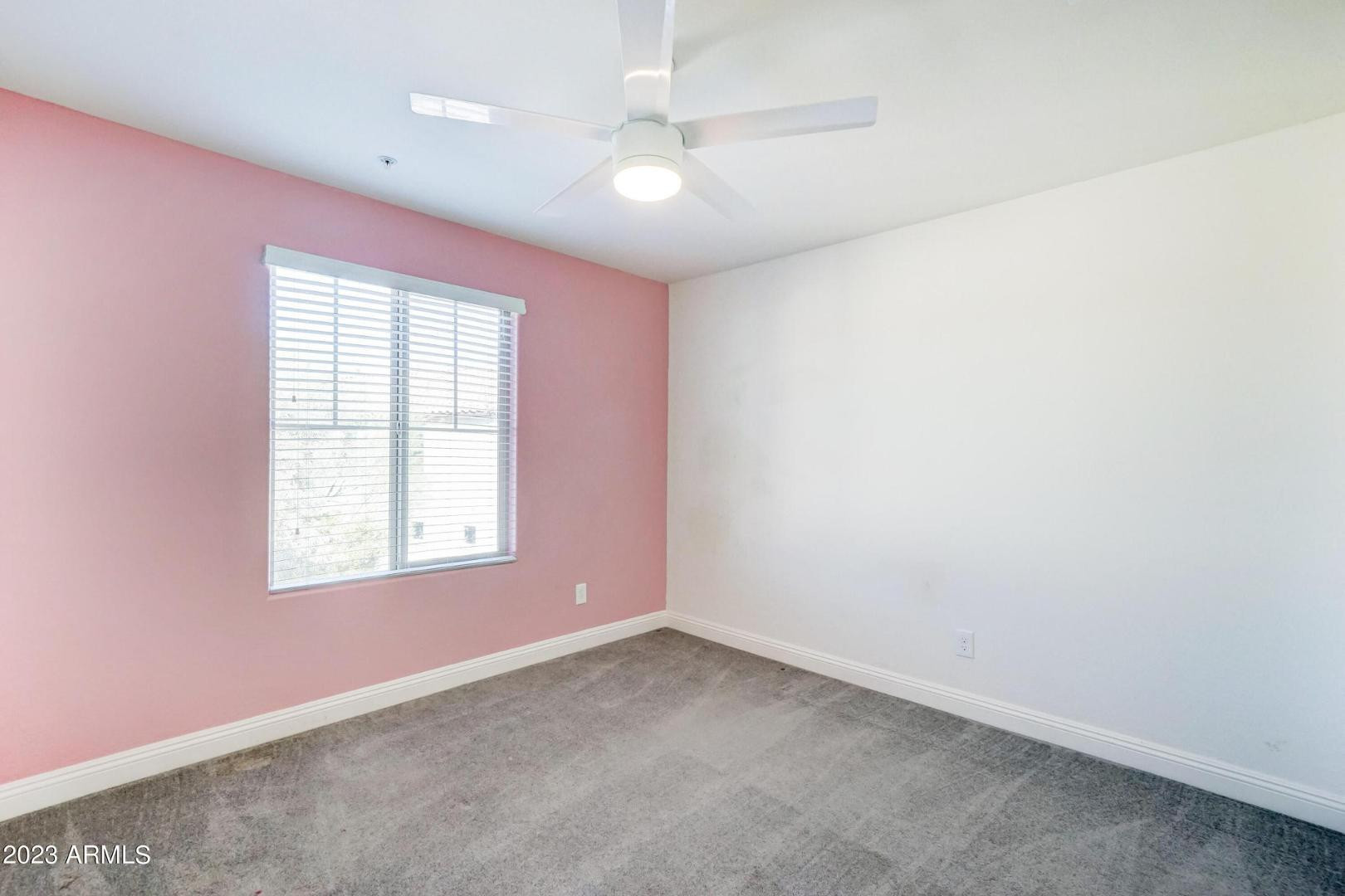 2297 North Alsap Road Buckeye, AZ 85396 - Photo 21 of 36 an empty room with a window and a fan