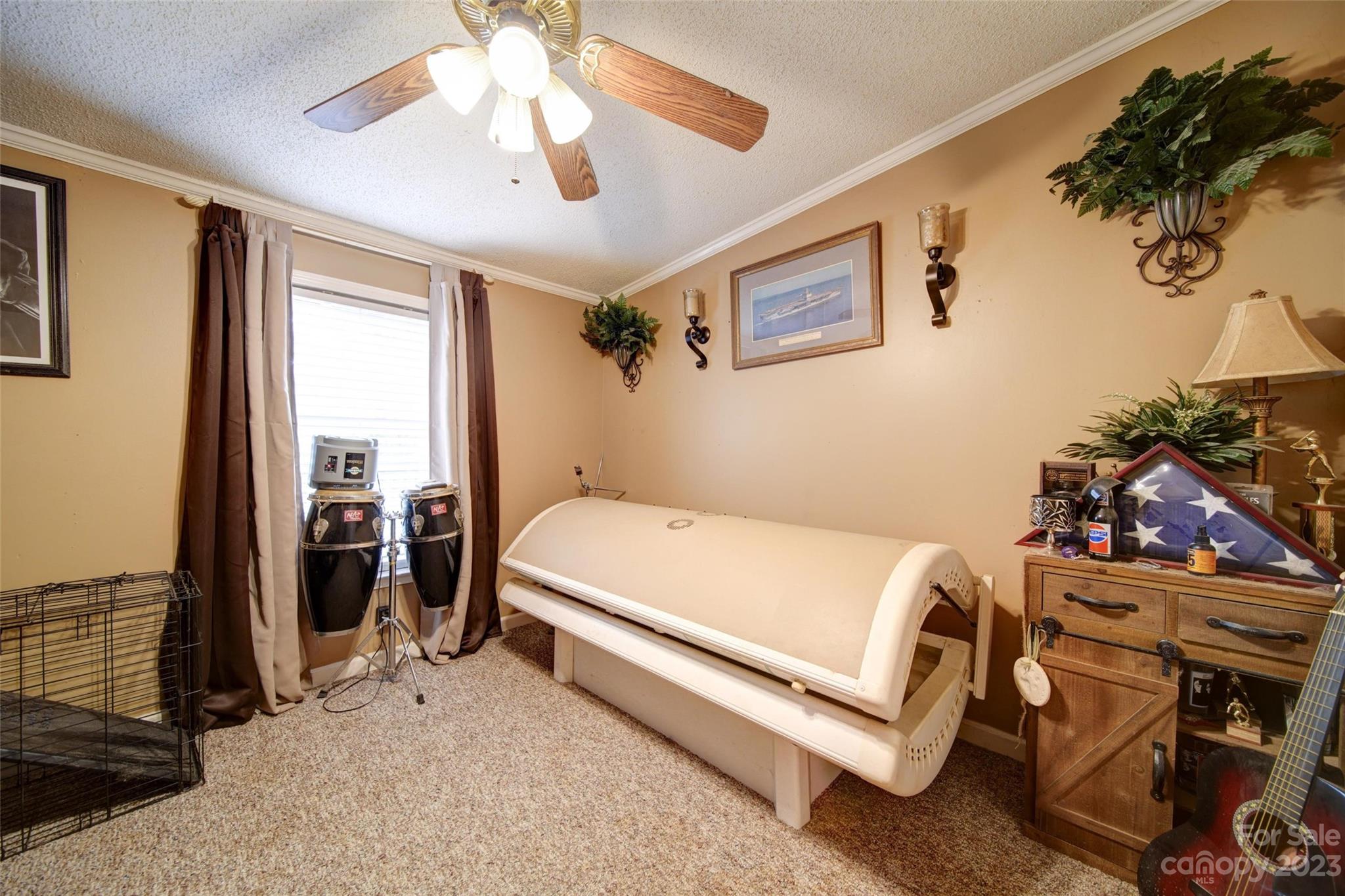 86 Edwards Store Road Peachland, NC 28133 - Photo 16 of 20 a bedroom with a bed and a chandelier