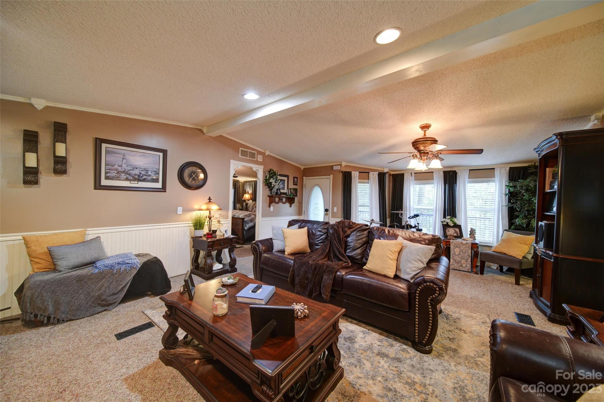 86 Edwards Store Road Peachland, NC 28133 - Photo 10 of 20 a living room with furniture a large window and a flat screen tv