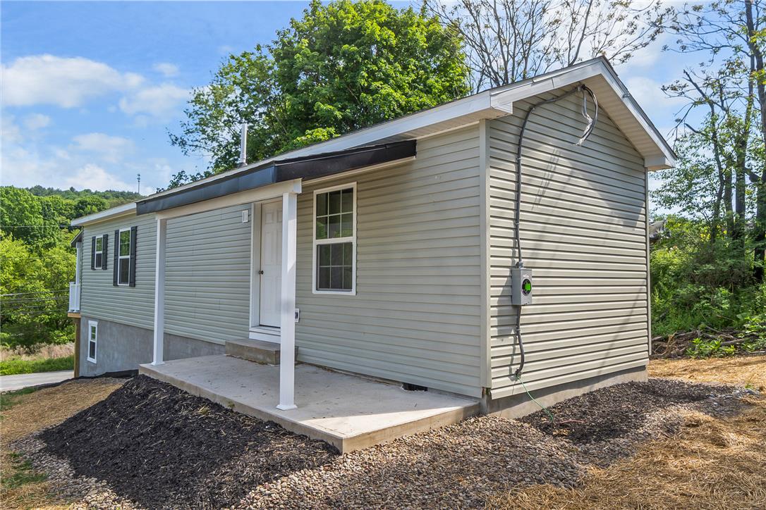 624 Main Road Lehighton, PA 18235 - Photo 38 of 42 A well-maintained side exterior presents light-toned siding and a covered front porch.
