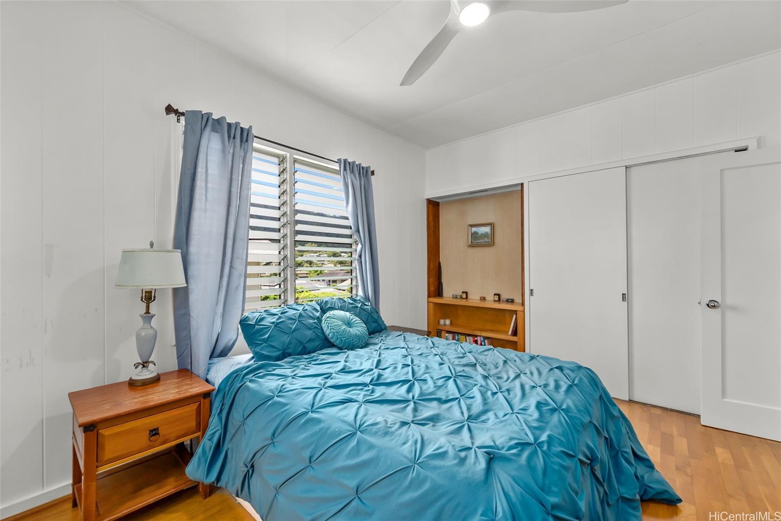 2811 Henry Street Honolulu, HI 96817 - Photo 14 of 25 A unique built-in wood shelving nook adds character and warmth to this already inviting bedroom space.