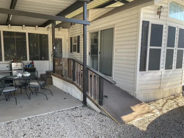 a view of a patio with table and chairs