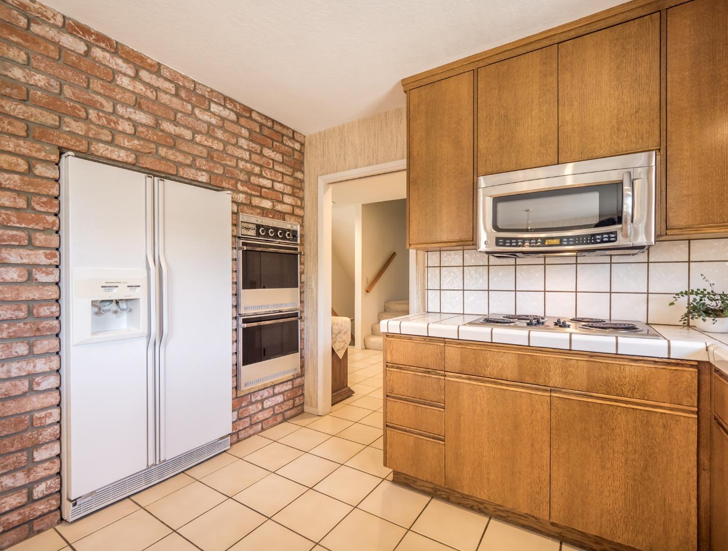 210 Greenbrier Drive Aptos, CA 95003 - Photo 20 of 63 a kitchen with stainless steel appliances a refrigerator and a stove top oven