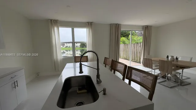 a view of a dining room with furniture window and outside view