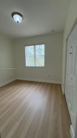a bathroom with a sink a toilet a mirror and shower