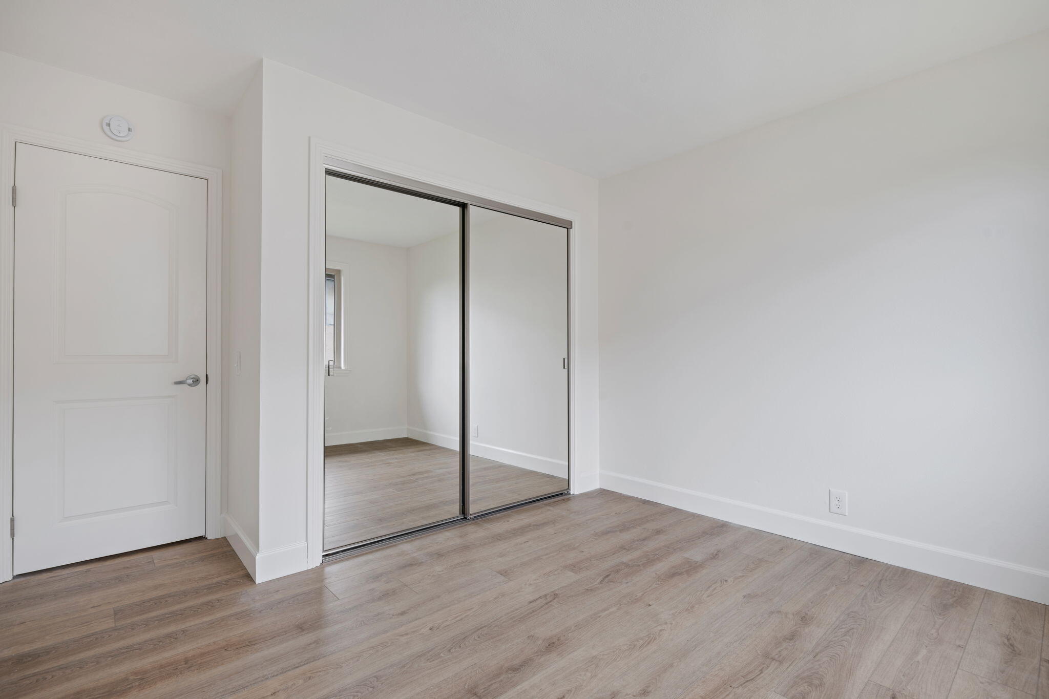 5930 Via Real, Unit 3 Carpinteria, CA 93013 - Photo 13 of 25 an empty room with wooden floor & door