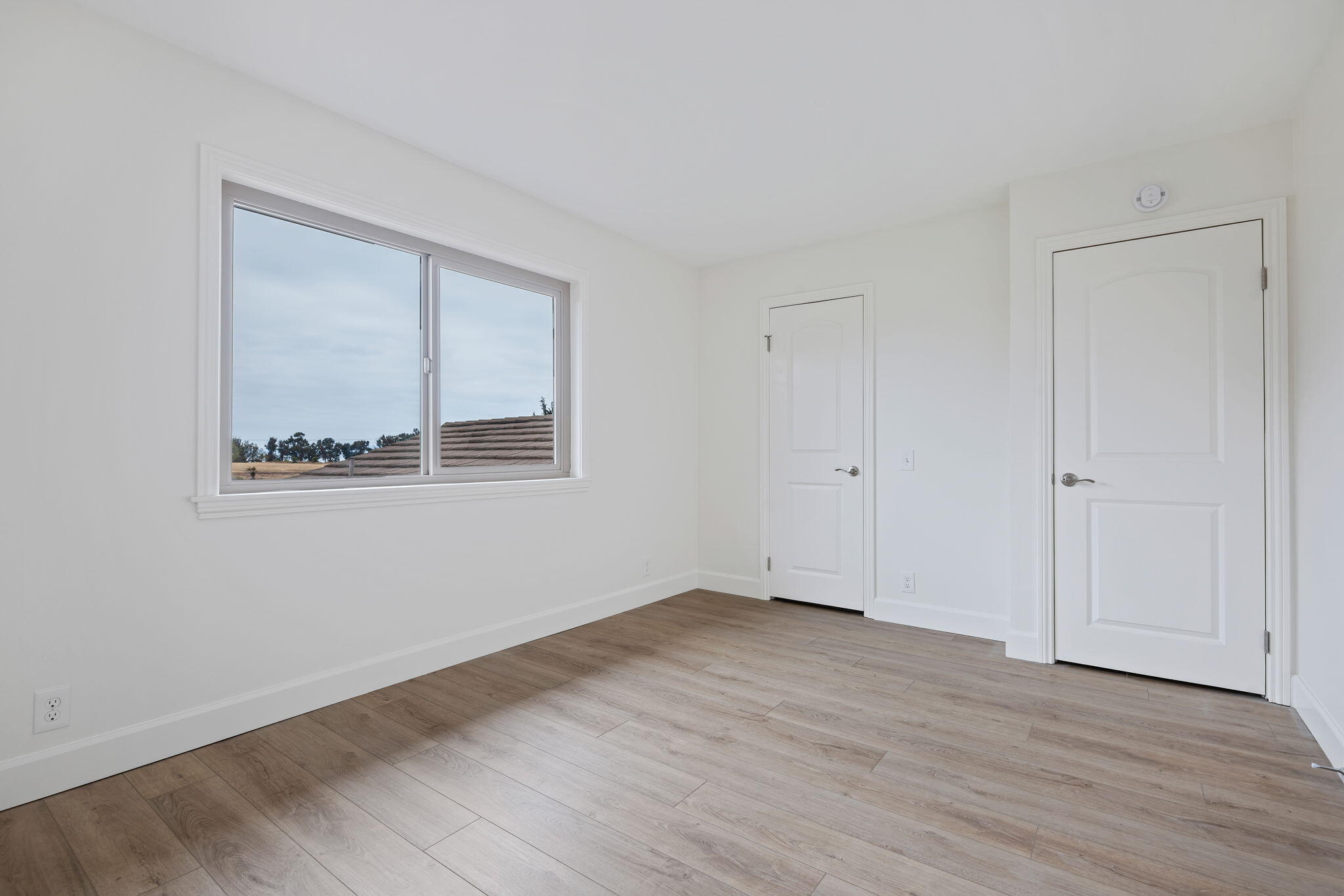 5930 Via Real, Unit 3 Carpinteria, CA 93013 - Photo 15 of 25 a view of an empty room with wooden floor and a window
