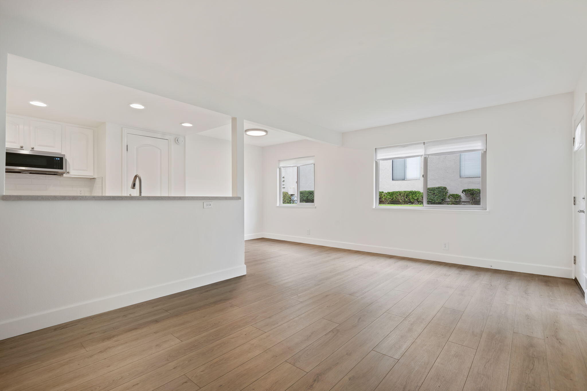 5930 Via Real, Unit 3 Carpinteria, CA 93013 - Photo 6 of 25 an empty room with wooden floor and windows