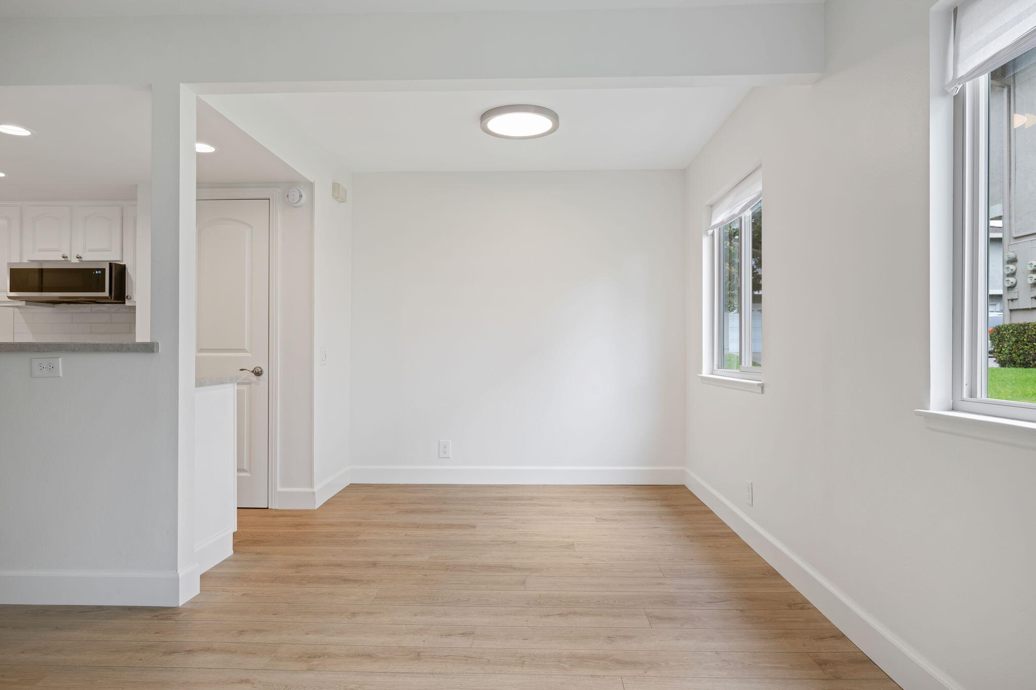 5930 Via Real, Unit 3 Carpinteria, CA 93013 - Photo 8 of 25 a view of an empty room with wooden floor and a window
