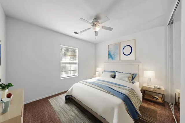 a bedroom with a bed and a window