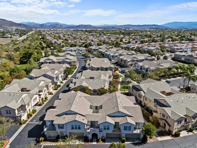 an aerial view of residential houses with city view