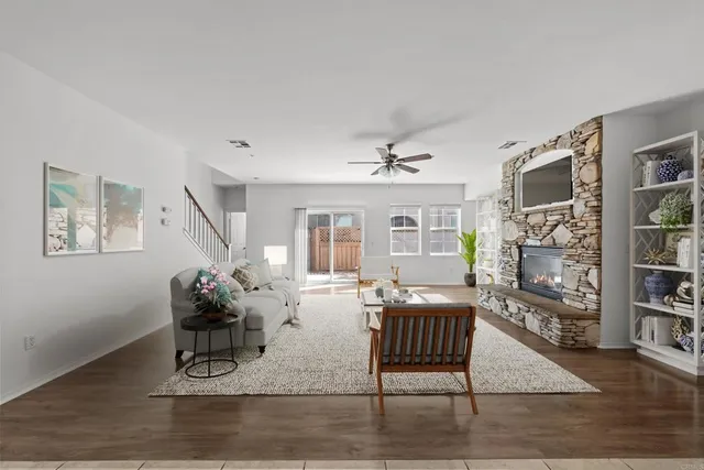 a living room with furniture and wooden floor