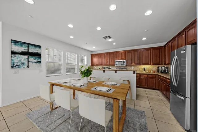 a kitchen with kitchen island a counter top space cabinets and stainless steel appliances