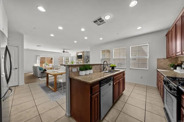 a kitchen with stainless steel appliances granite countertop a stove and a sink
