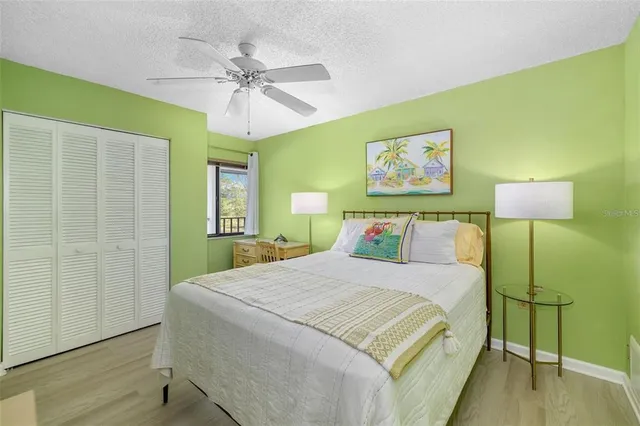 a bedroom with a bed and a painting on the wall